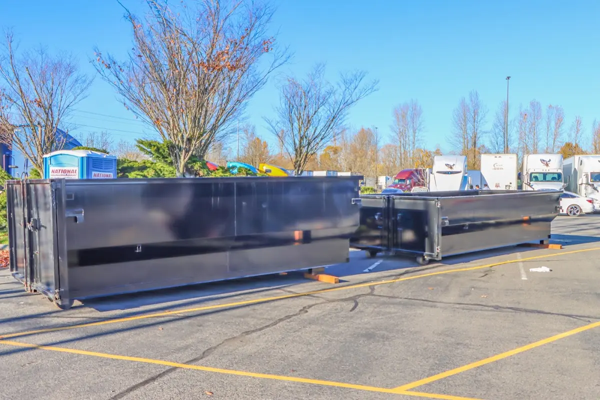 Professional dumpster rental service with roll-off container on residential driveway in Shiloh